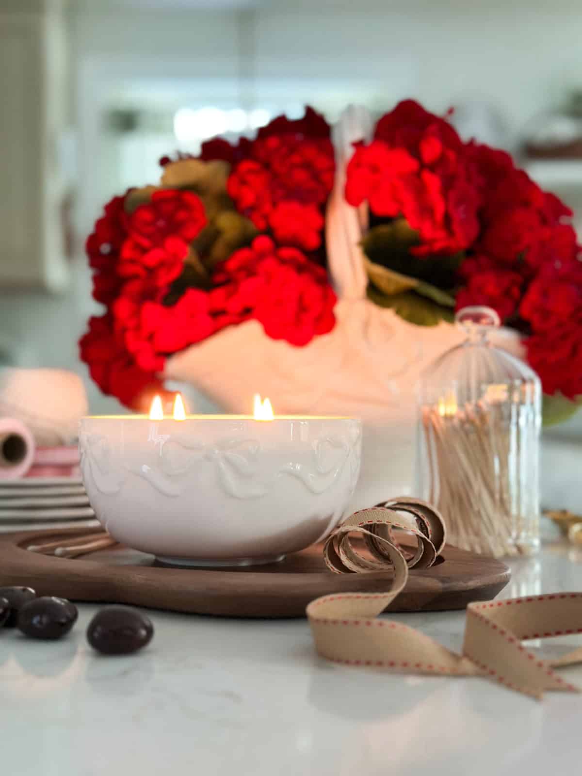 red roses in a white container and other white and wood items
