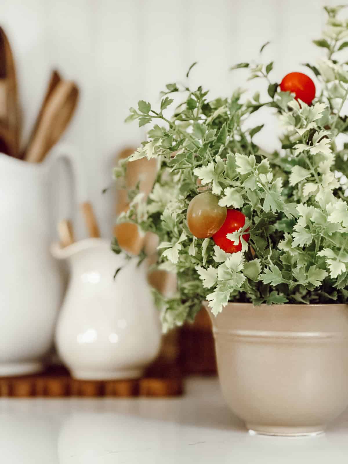 ceramic planter filled with faux greenery with faux red berries