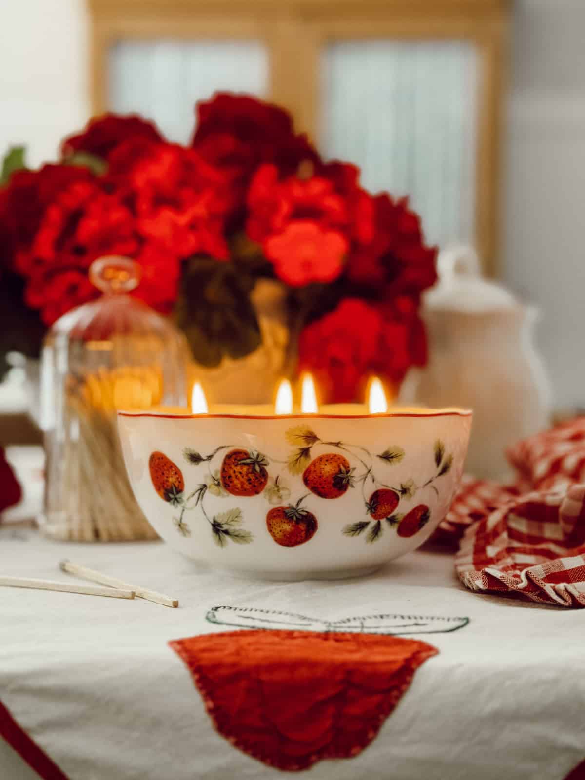 ceramic bowl with strawberry design on exterior turned into a 4 wick candle