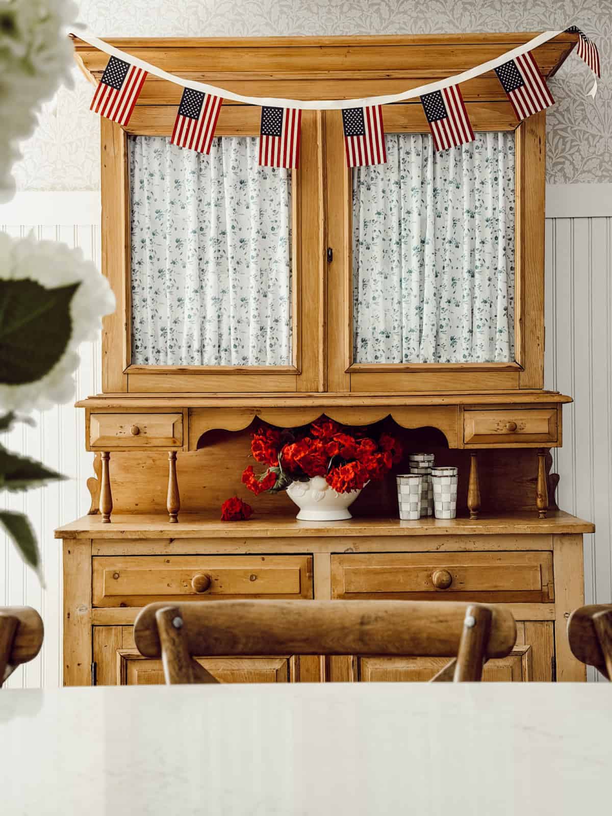 pine wood buffet with American flag garland across the top