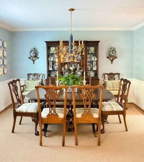 traditional brown furniture in a small dining room with blue grasscloth wallpaper