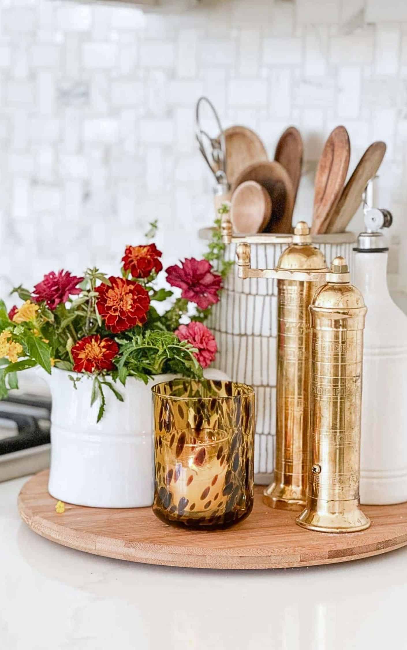 fall vignette with red flowers on a kitchen counter