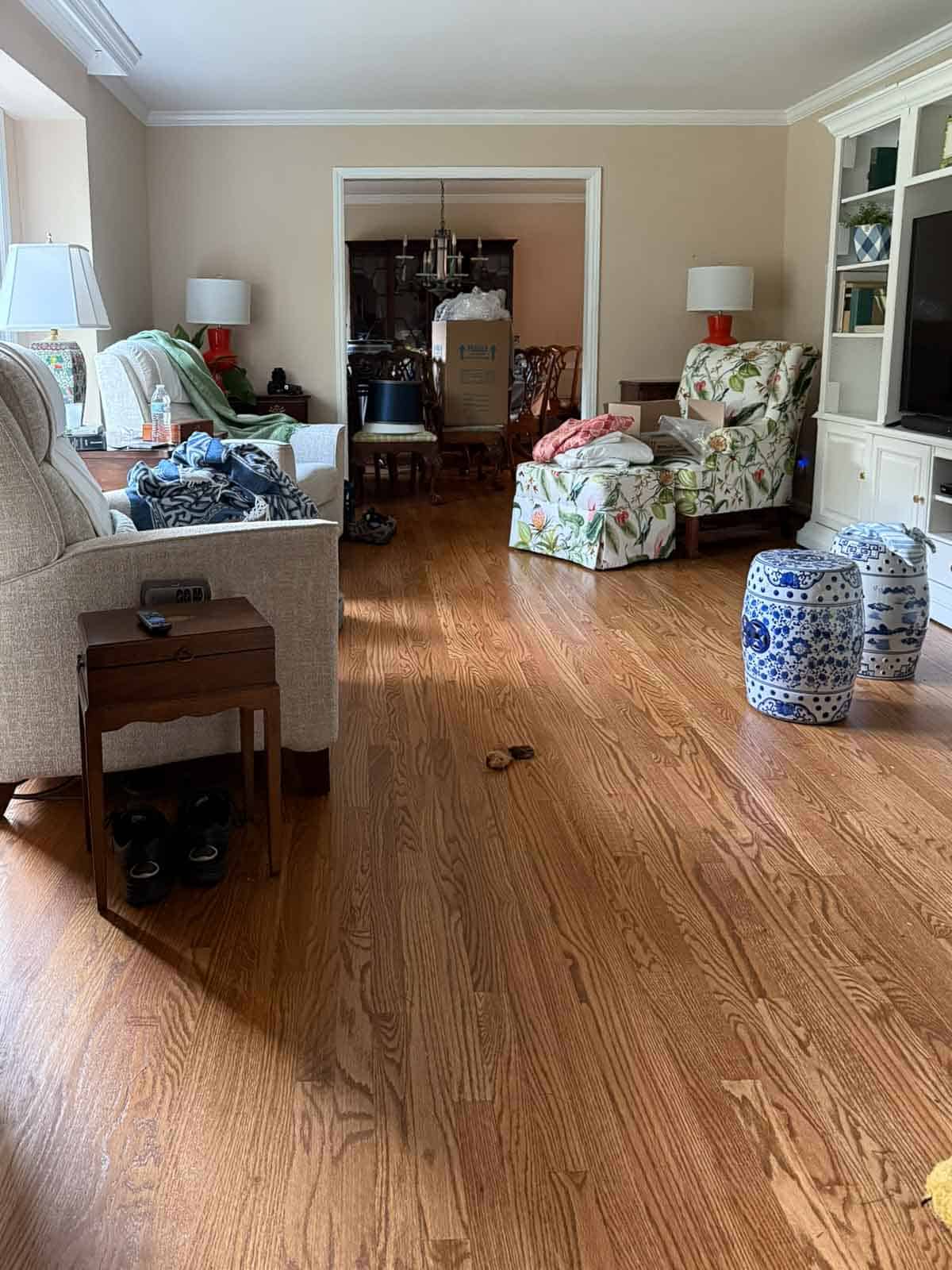 living room with hardwood floors and scattered furniture