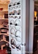 multiple pot lids stored on the back of a pantry door
