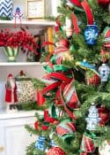 Chinoiserie Christmas tree decorated with red and green ornaments and blue and white Chinoiserie ornaments and tartan plaid ribbon