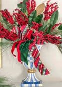 blue and white urn filled with Christmas greenery and plaid ribbon